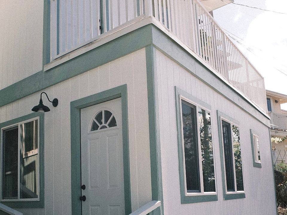 Front of house with carport under