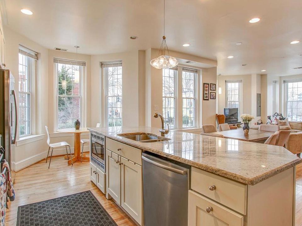Alternative kitchen view that shows room for kitchen table by the windows.