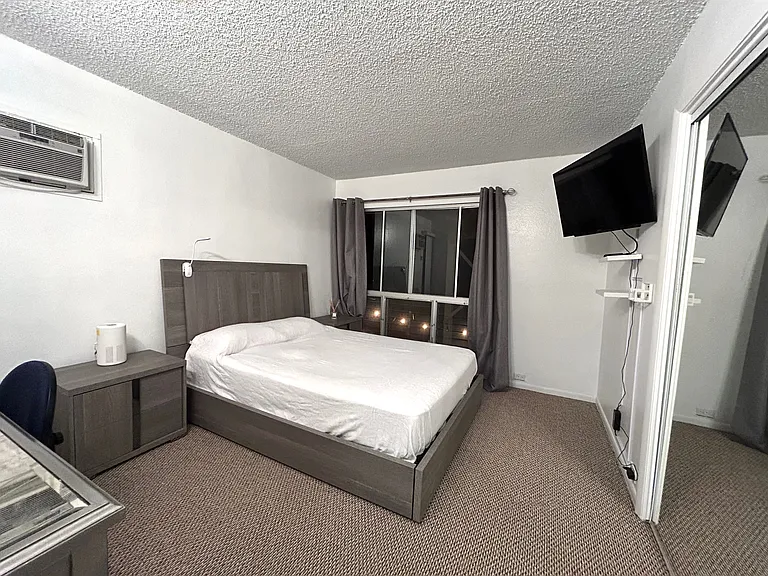 Bedroom one downstairs with ocean/mountain/pool views.