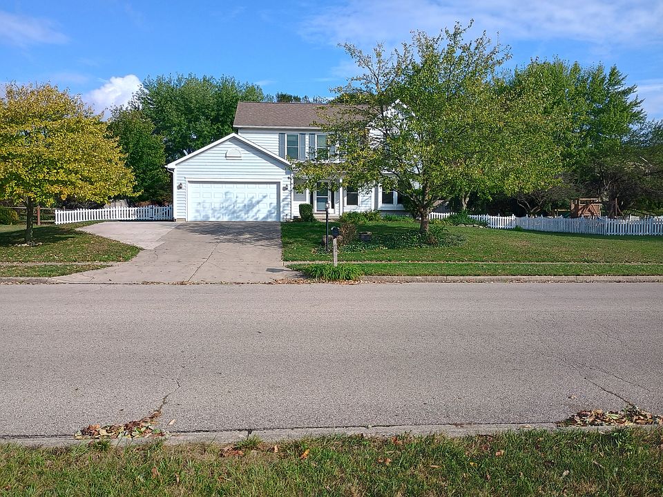 Front of house with white picket fence