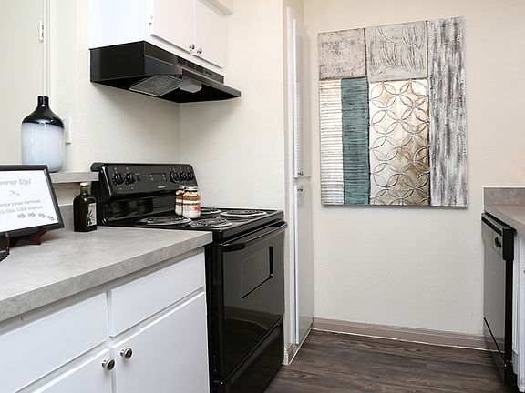 Kitchens with black appliance packages and some with wood-lo