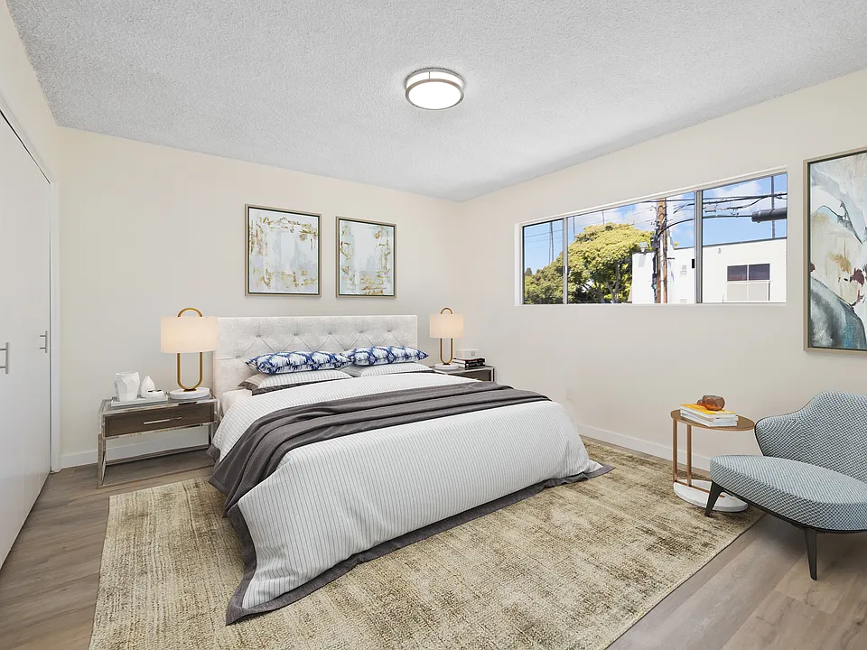 Spacious bedroom with great natural sunlight and substantial closet space with hardwood flooring.
