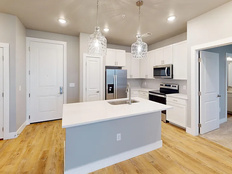 Sling Station is a two-bedroom apartment with an open-concept floor plan, which includes a large kitchen island. Sling Station is a two-bedroom apartment with an open-concept floor plan, which includes a large kitchen island.