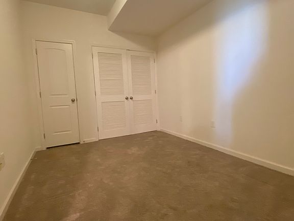 Den with utility closet and storage closet