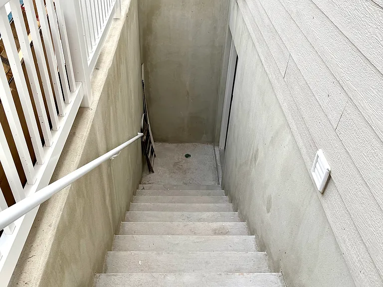 Basement Entrance with large concrete Pad