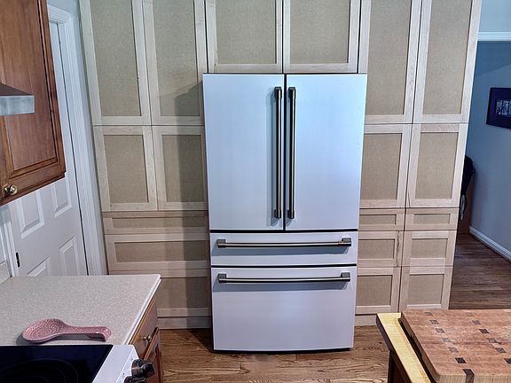 Brand new Cafe Refrigerator complete with wine drawer and freezer drawer. New custom cabinets and deep storage drawers surrounding the fridge (to be painted prior to lease start)