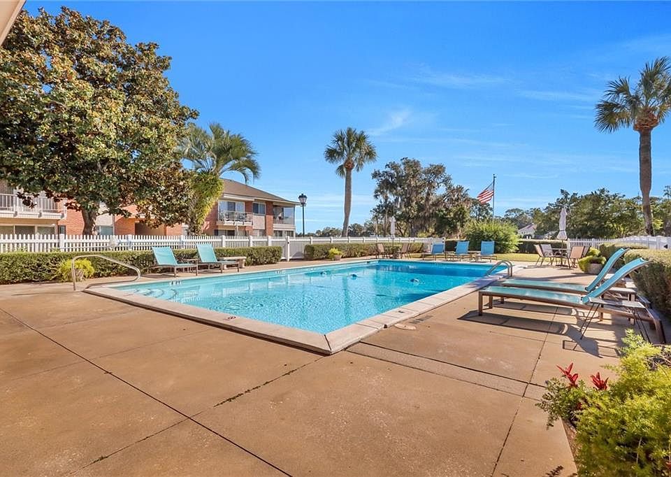 Community pool overlooks the golf course. Tables, lounge chairs , umbrellas and men's and women's rest rooms for your convenience