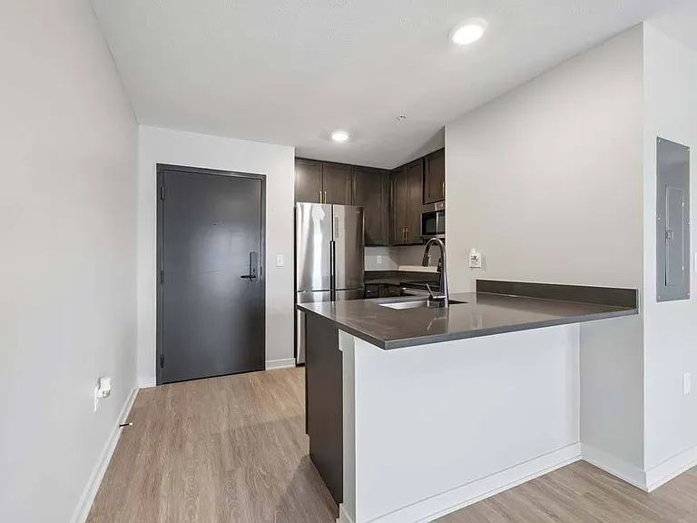 Framed by crisp finishes and generous counter space, this inviting kitchen is designed to elevate every meal and gathering.