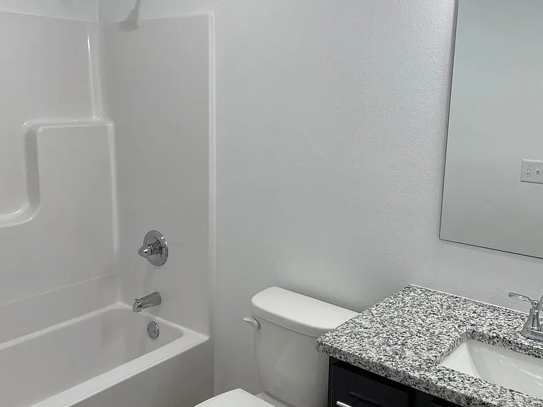Main floor hall bathroom with granite countertop.