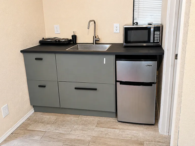 Remodeled shed - kitchen - hotplate with 2 burners, mini fridge, sink, microwave