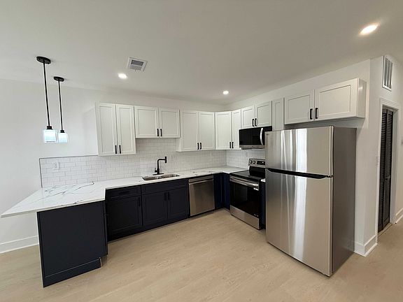 Kitchen with new stainless-steel appliances.