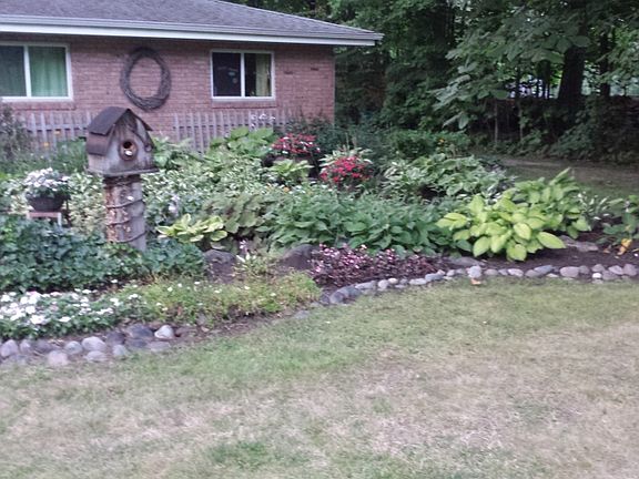 mostly brick siding on this sprawling ranch, beautiful gardens surrounding this home. Don't forget to notice the second lot with a separate driveway to the east of the house which gives the  second storage building easy access. 
