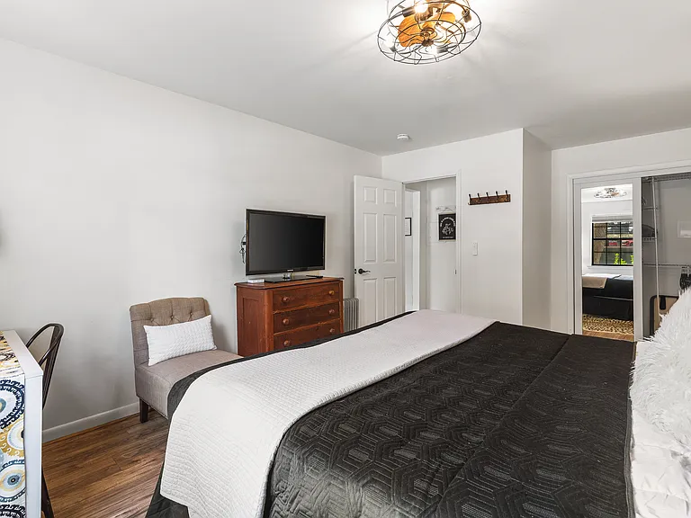 Comfortable King bed in the bedroom. Includes a smart TV, desk to get ready at, dresser and a closet to store your items in.