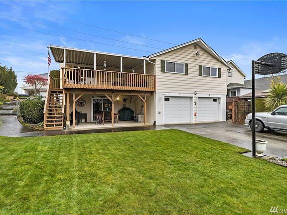 Extended driveway with ample parking behind a gated fence, cement walk-way from front yard, large fenced and landscaped yard, covered deck, covered patio, storage shed, basketball hoop, sprinkler system and much more!