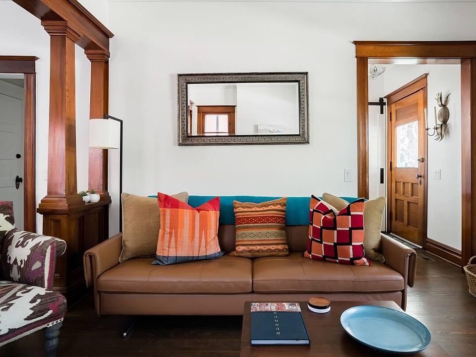Living room with view to front door and entry closet (see barn door)