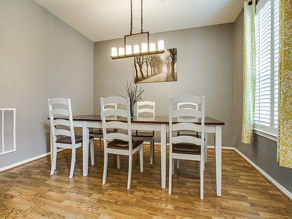 Room at the front of the house is currently used as a dining room.  On-trend paint color with easy to care for pergo floors.