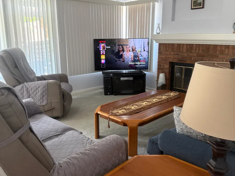 Family room features fireplace and sliding glass door to tropical oasis-gazebo, pool, spa, sitting and dining area, trees and low maintenance zoysia lawn.