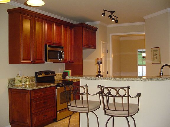New 42’ cherry cabinets w/granite countertops and breakfast bar. 