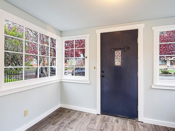 Front entrance sunroom with new flooring and coat closet.