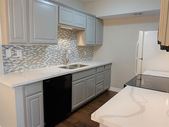 Amazing updated kitchen with new quartz counter tops, new back splash and freshly painted cabinets.