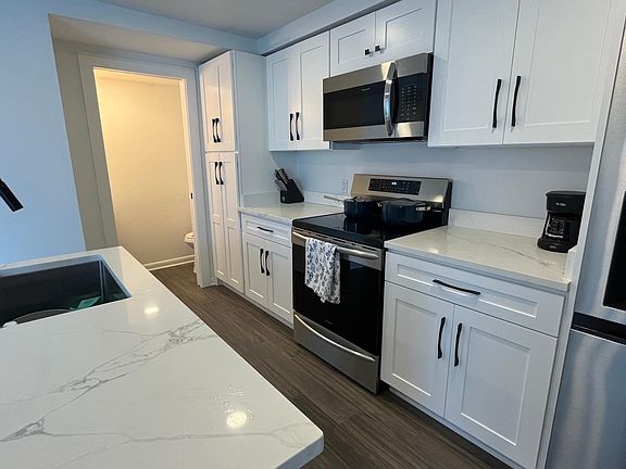 Including an induction stove, dishwasher, fridge/freezer with ice maker and water dispenser and microwave - oh and a full height pull out pantry