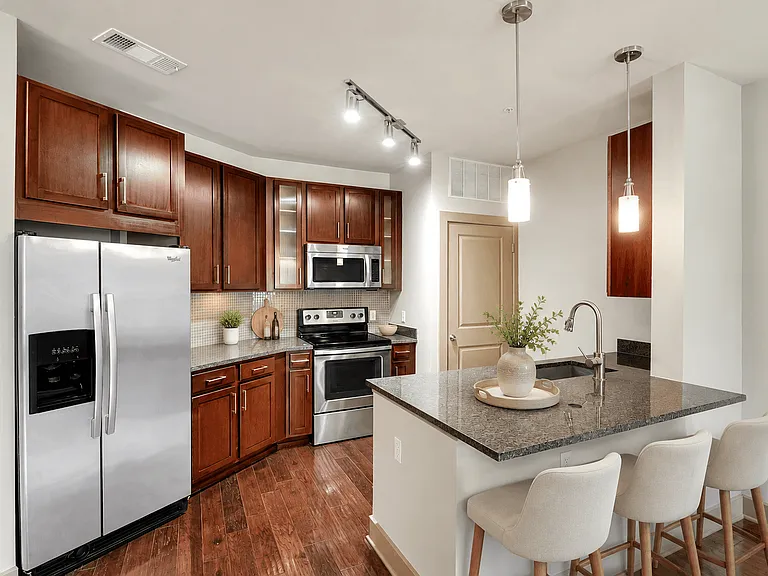 A kitchen with a refrigerator, stove, and oven.