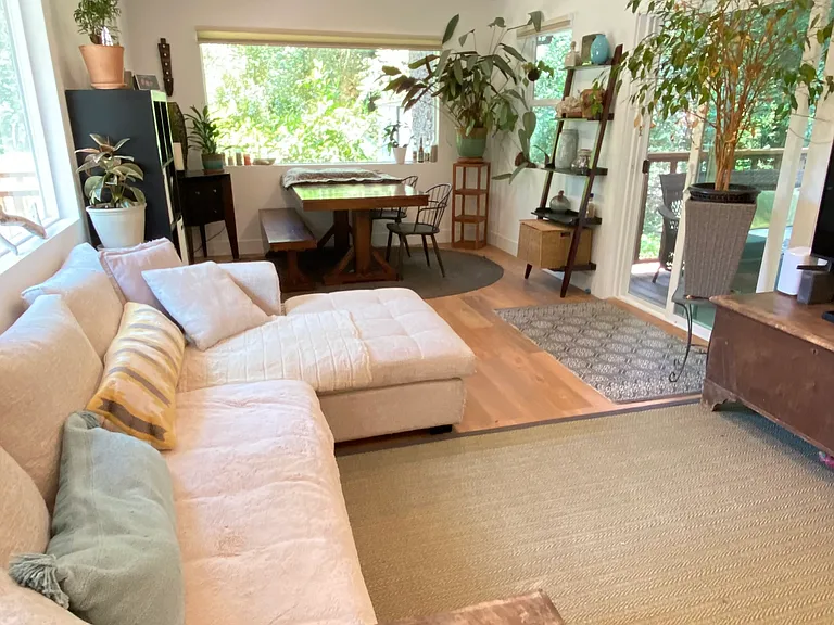 Open living/dining space with doors to private deck