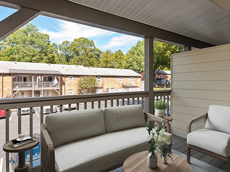 Relax and unwind on this charming balcony overlooking lush greenery.
