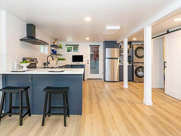 View from Living Area into Kitchen, the bath is located through the sliding barn door on the right.