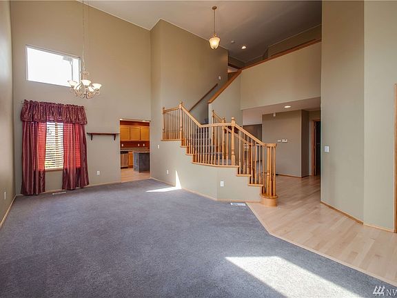 The entry opens into the carpeted living room, with easy access to the kitchen, dining areas, and upstairs.  All hardwood flooring is newly professionally refinished.
