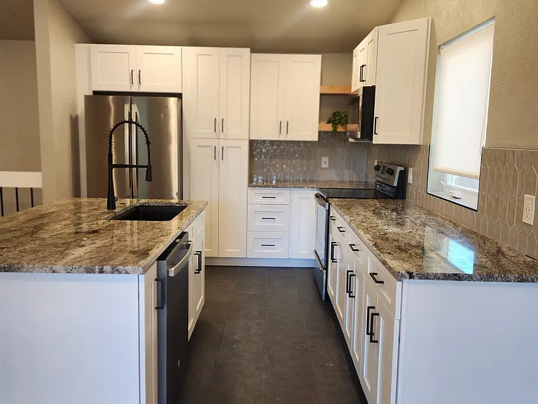 Granite countertops and plenty of cabinet space with soft close doors and drawers.