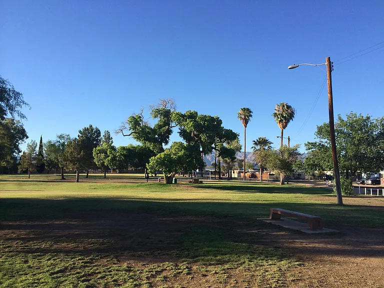 Alvernon neighborhood park with walking/running path. Baseball field, practice basket ball court, Swing and jungle gym. 3 picnic tables.