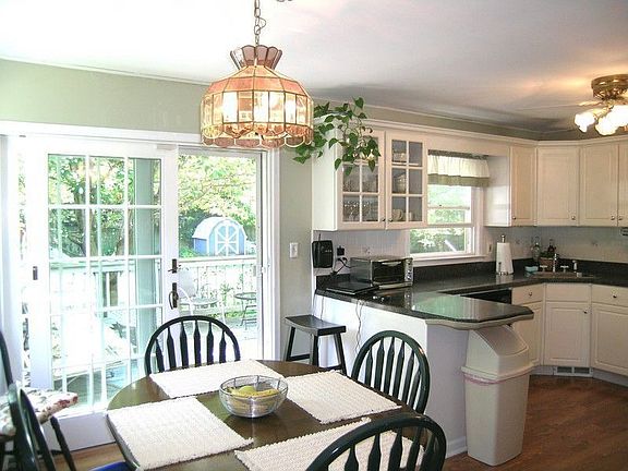 Slding glass doors lead from eat-in kitchen to deck overlooking rear yard