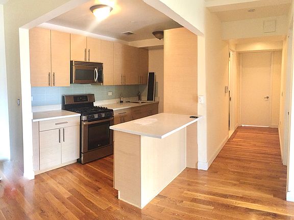 Kitchen with stainless steel appliances, island and granite