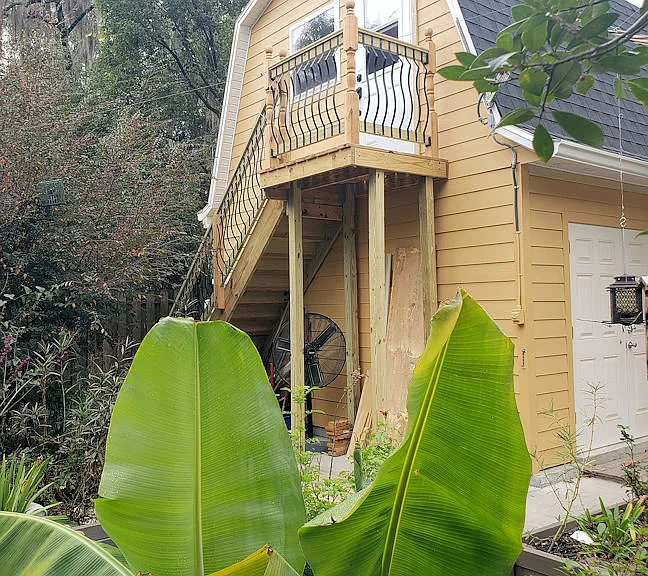 Yard view of studio and access stairs, viewed from the garden. You can see it is not connected to the rest of the house, providing privacy for both the studio tenant and the homeowners.