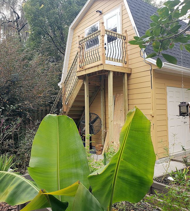 Yard view of studio and access stairs, viewed from the garden. You can see it is not connected to the rest of the house, providing privacy for both the studio tenant and the homeowners.