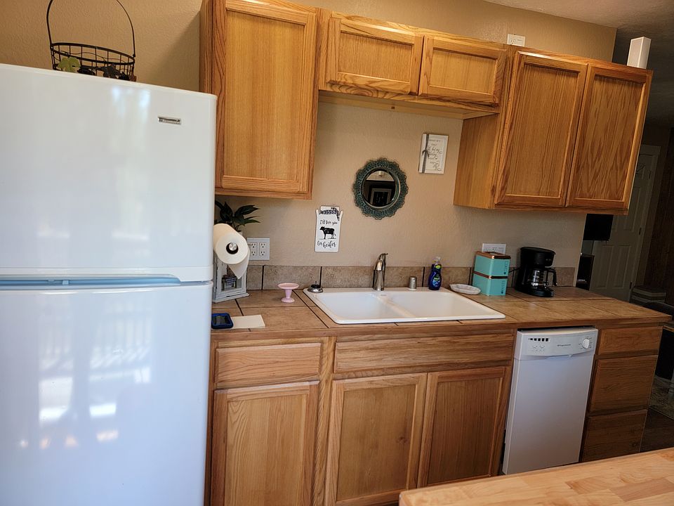 Galley kitchen, sink side with dishwasher.