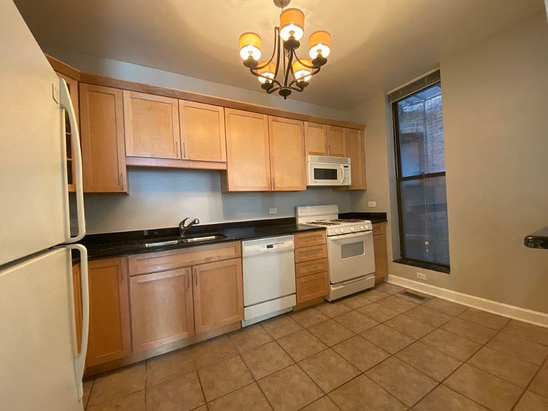 Kitchen featuring stainless steel appliances, granite countertops, dishwasher and gas range
