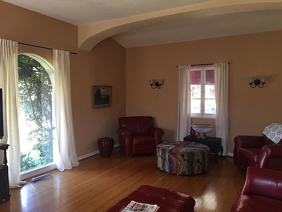 View of living room with beamed, high ceilings