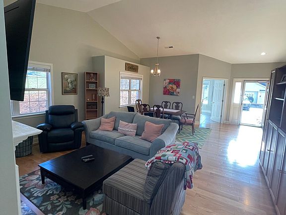 Living and dining area, front entry and kitchen entry