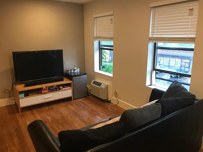 Open floor plan- furnished living room with sofa and entertainment center