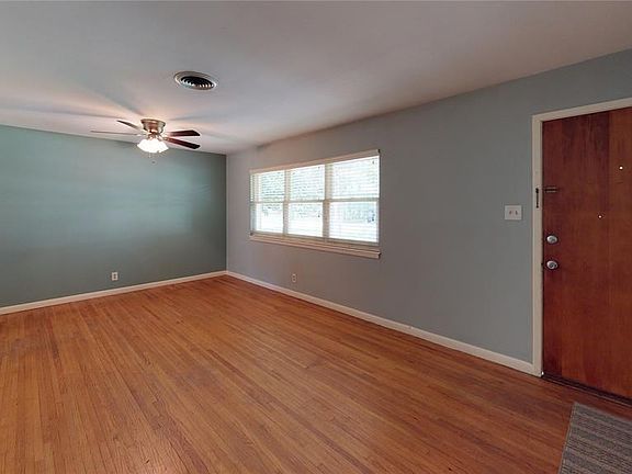 Open space with original floors. Great for living room/den. Energy-efficient windows and a ceiling fan make this room comfortable and ideal for lounging.