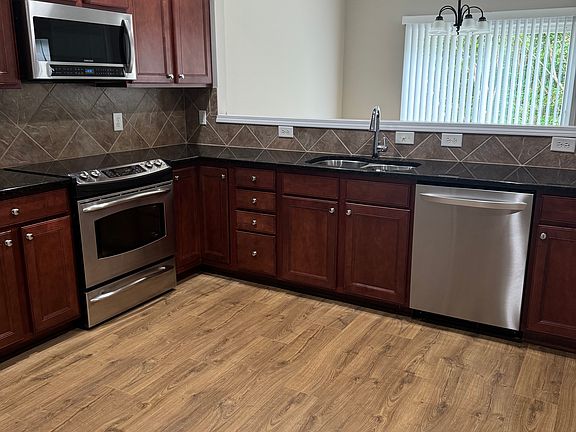 View of the kitchen thru to the dining room with sliding glass doors to your private patio.