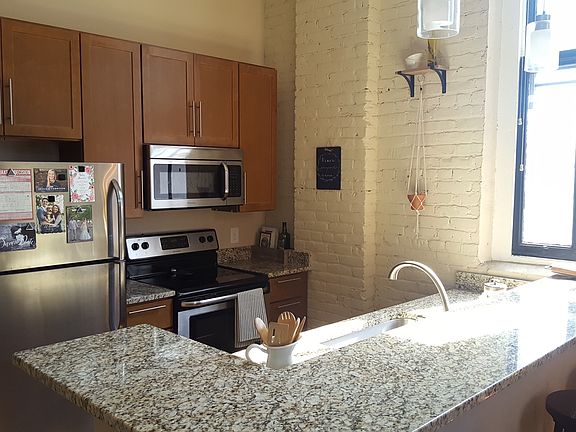 The updated kitchen features granite counter tops and stainl