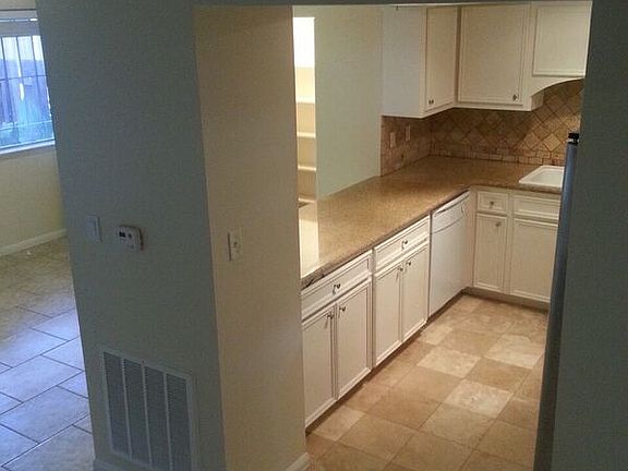 stairs looking to den and kitchen
