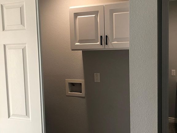 Laundry hookup with cabinet.