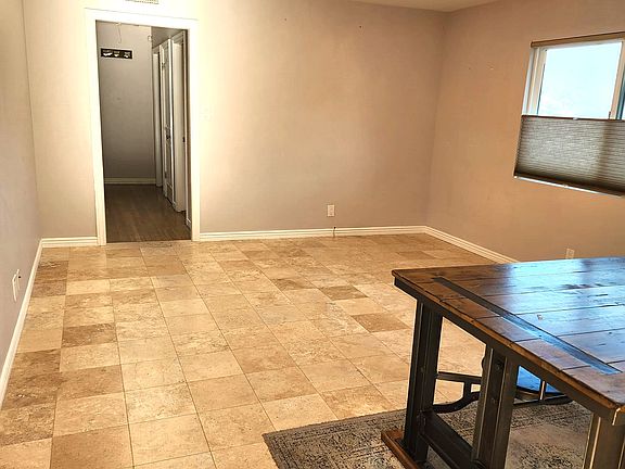 Great room with dining/family area. Kitchen to right and behind. Deck through French doors to right.