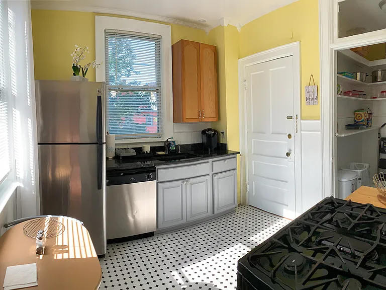 [Kitchen] Features brand new stainless steel appliances. Kitchen door leads to rear stairway.