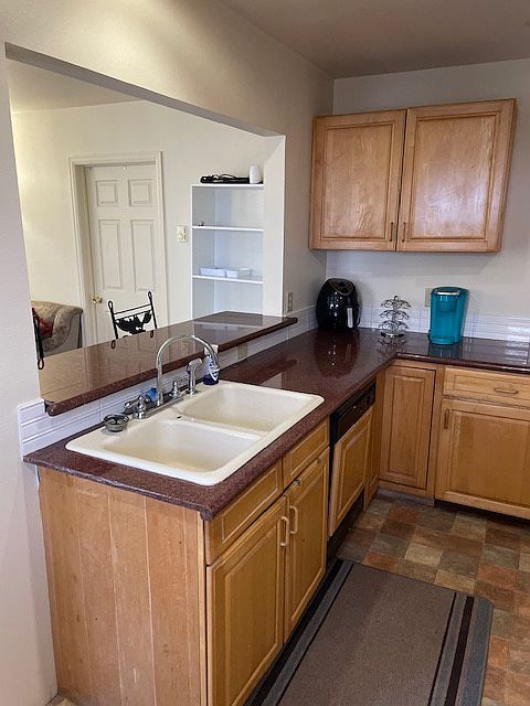 While working at the sink, you are facing the living area.
