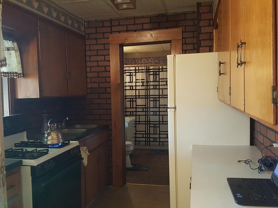 Kitchen with bathroom beyond